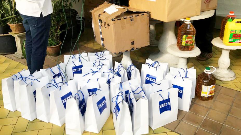 Image showcases the many paper bags with ZEISS logo on them - presents for the childern that were prepared by the ZEISS volunteers