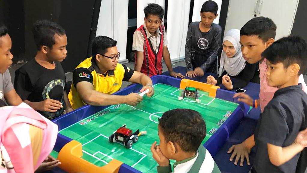 a group of children playing a game with cars