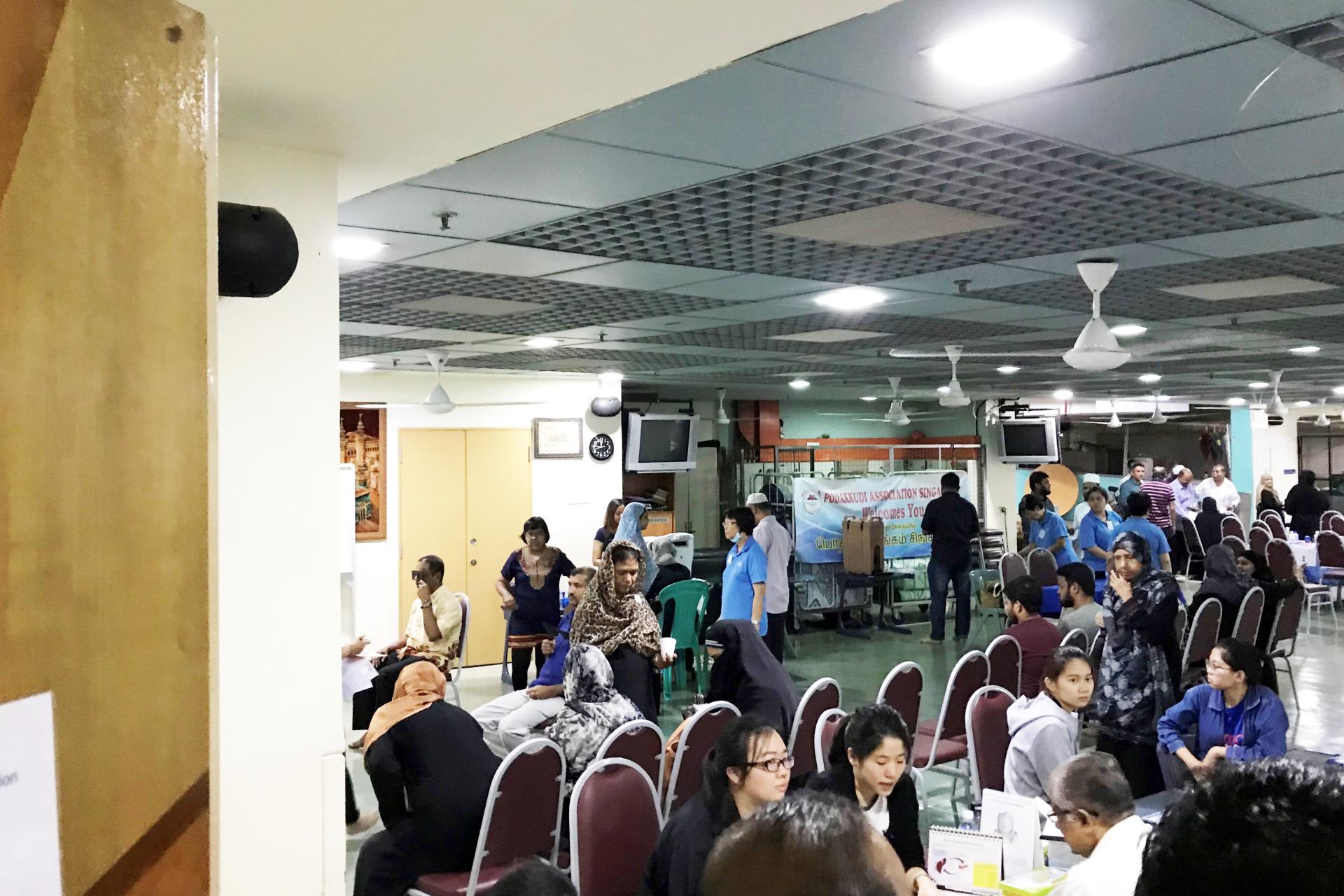 during Health Fair and Blood Donation Drive - a group of people sitting around tables in a room