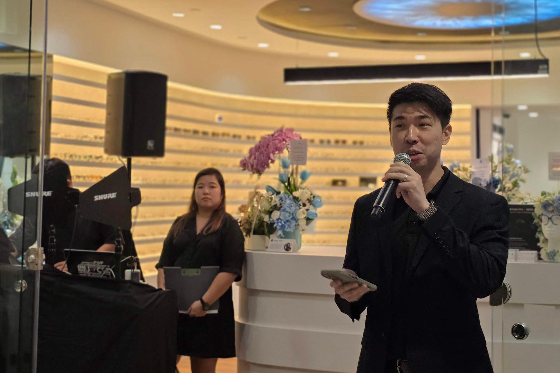 A official is speaking via a microphone at the Zeiss Vision Center opening in Singapore