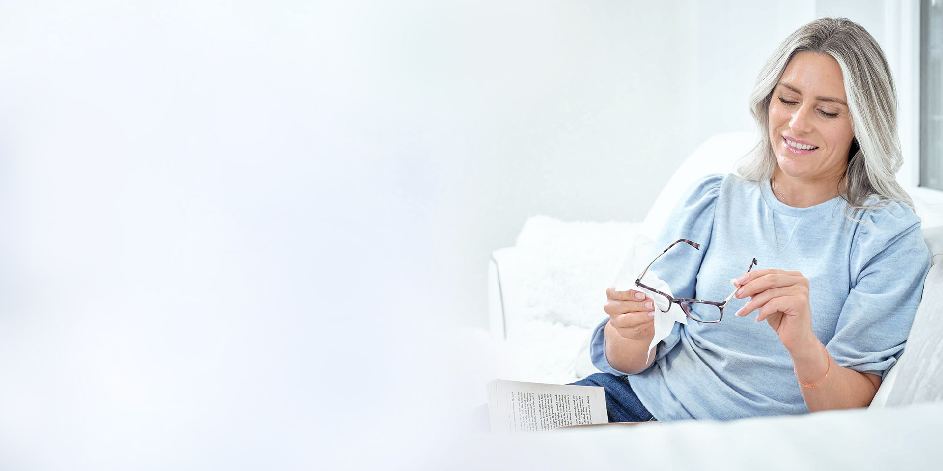 A woman cleaning her glasses