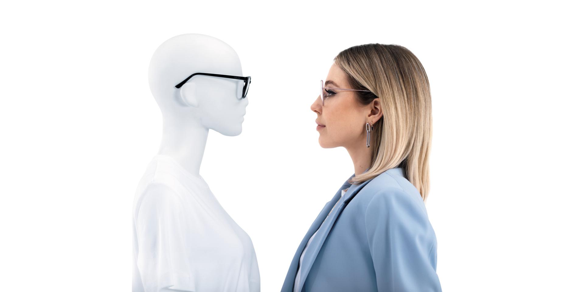 Woman wearing ZEISS ClearView glasses faces mannequin wearing glasses.