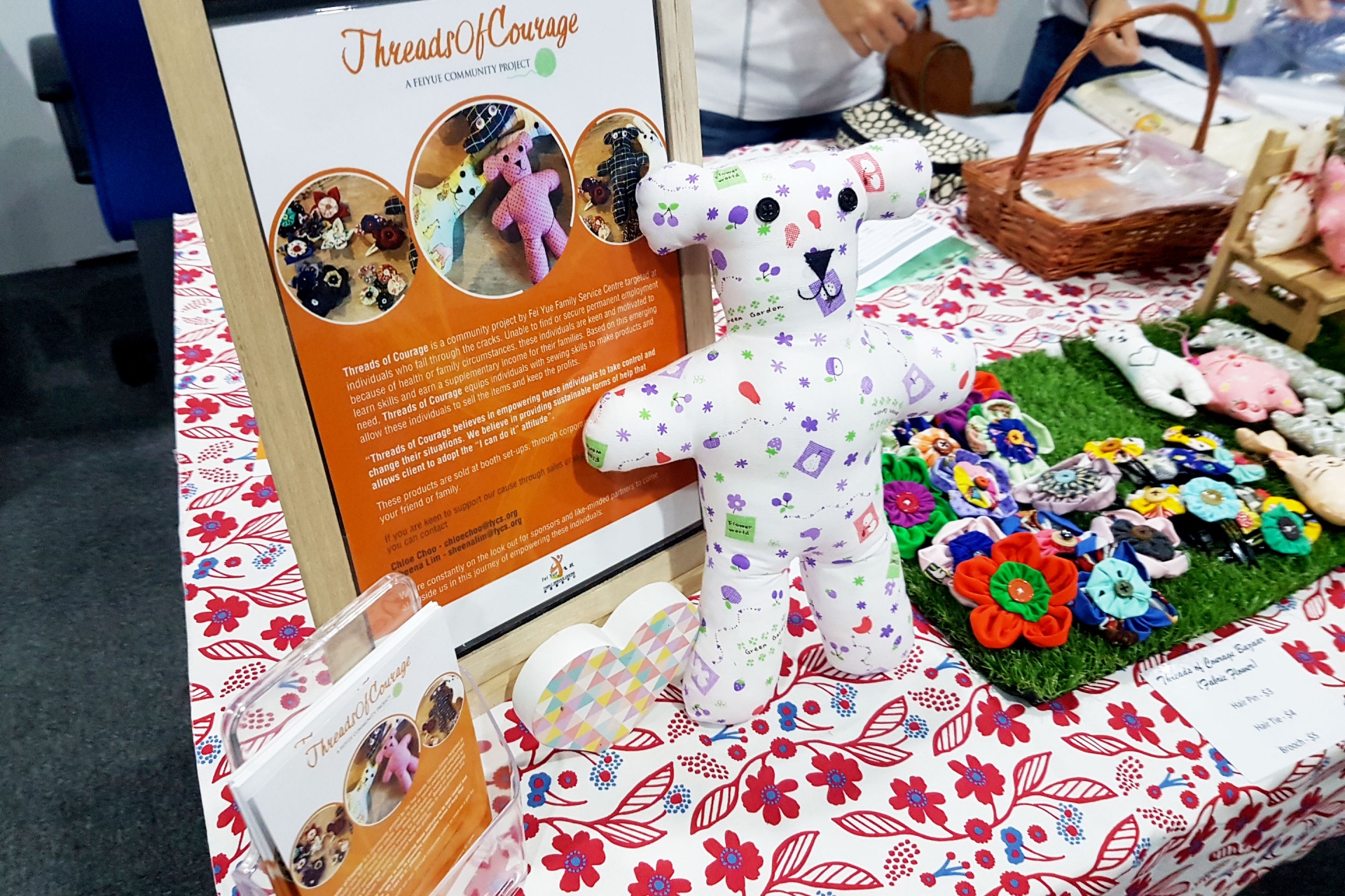 Image showing handmade items and flyers from the Threads of Courage (ToC) project.