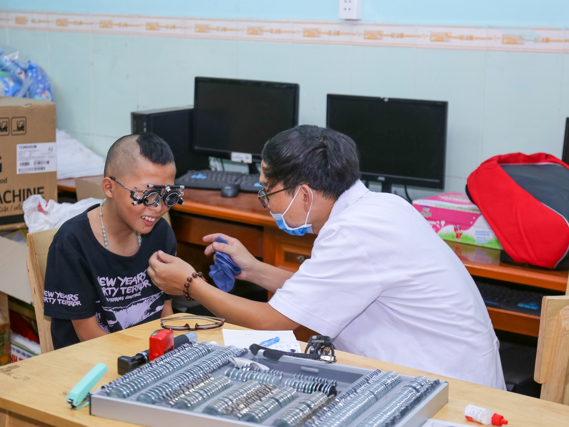 A doctor performs an eye examination on a child using ZEISS diagnostic instruments.