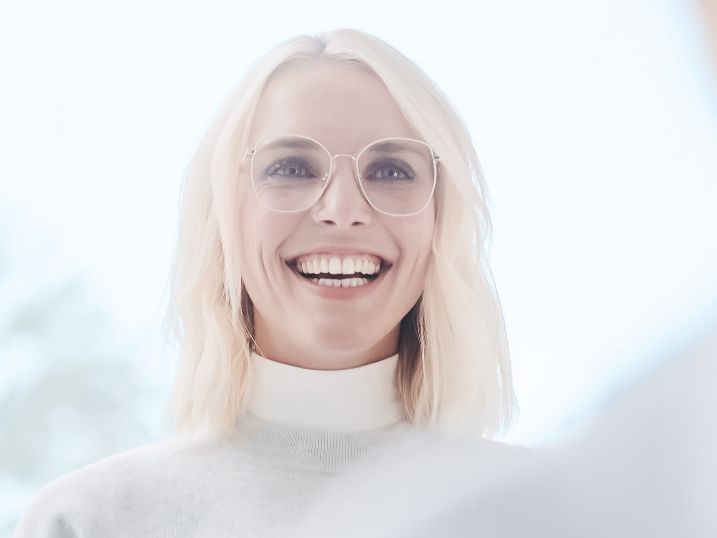 A woman with glasses smiling 
